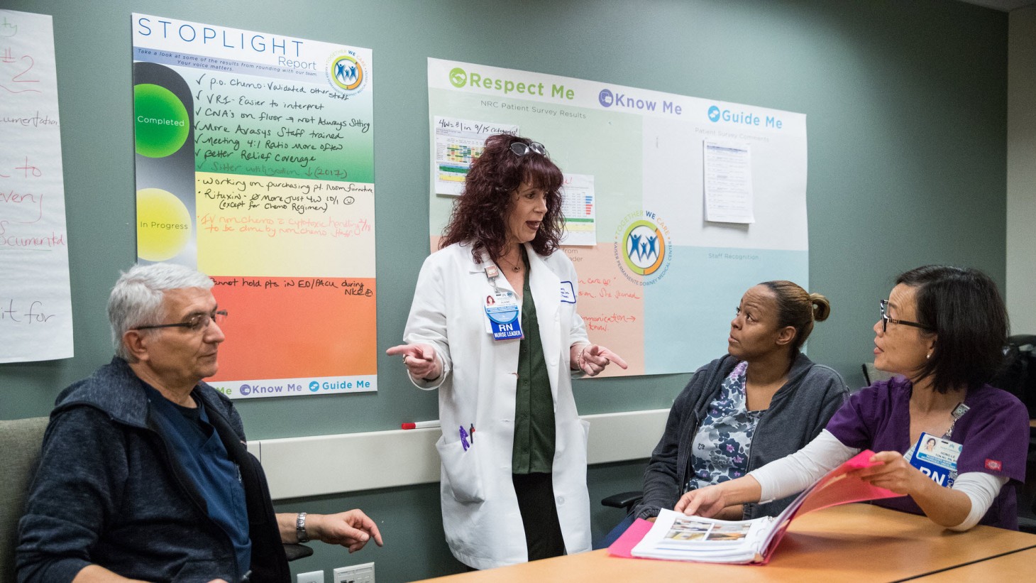 Nurse manager talks with her team.