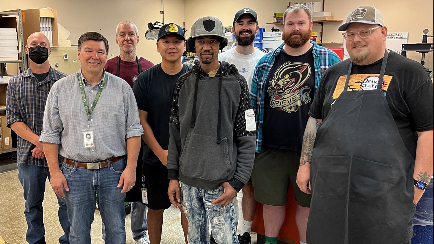 Group portrait of 8 men inside a room