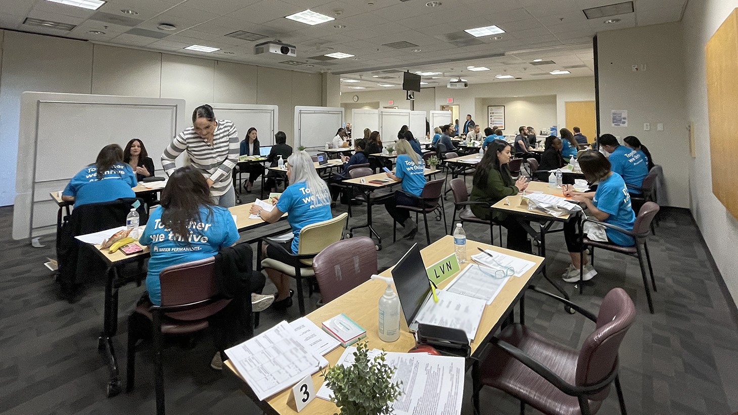 People gathered at desks in large room