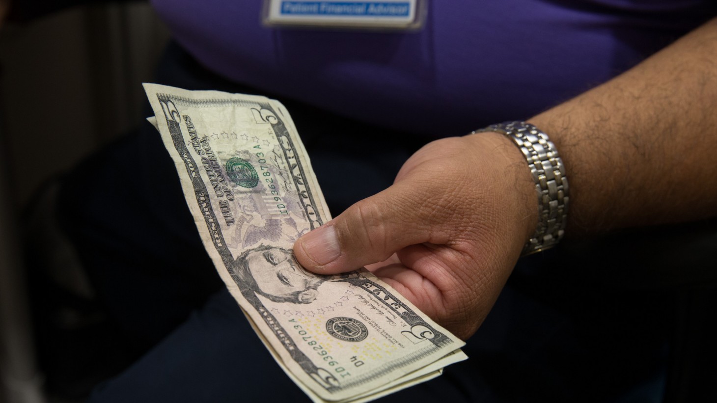 Man's hand holding cash 