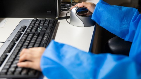 hands on a computer keyboard and mouse 