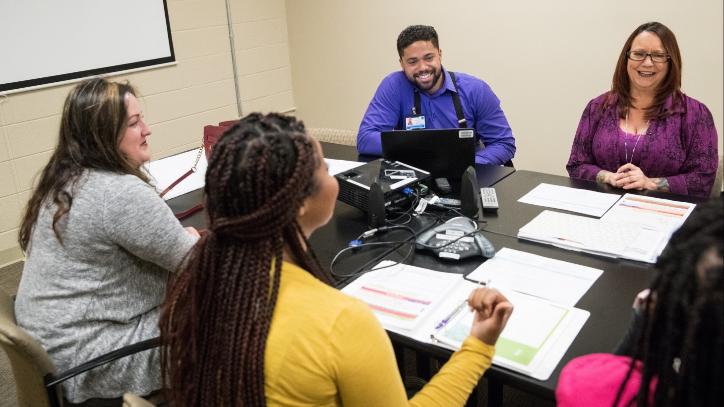 Four people meeting, smiling