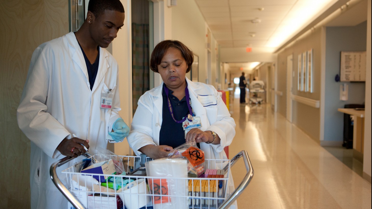 Two workers go over supply items